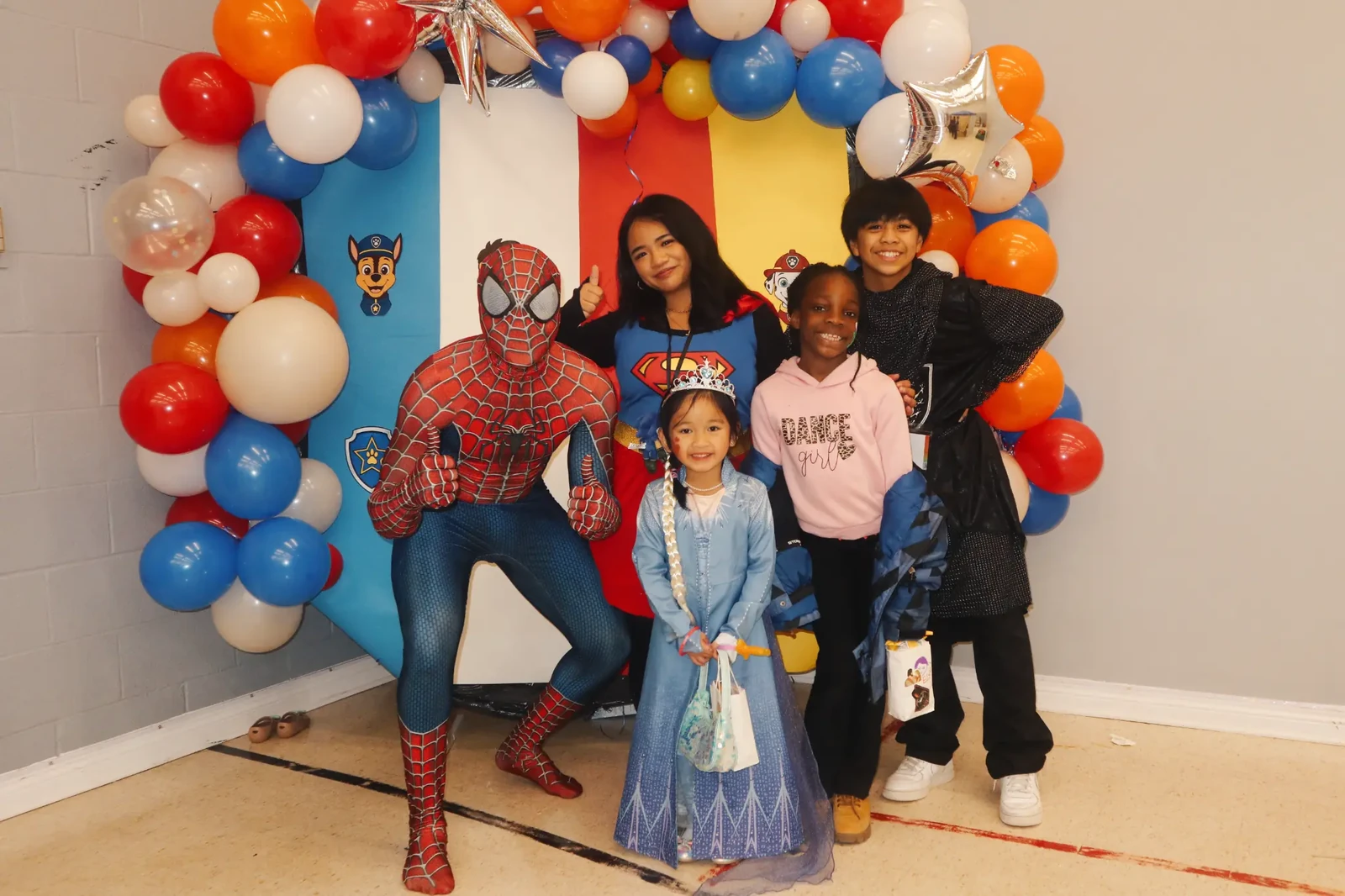 Children celebrating with Spider-Man and superhero entertainers at a Once Upon a Fun event
